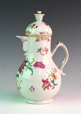 a white vase with a pink flower design on it
