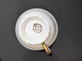 an overhead view of a coffee cup with a gold rim