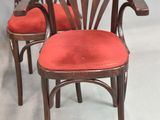 three wooden chairs with red upholstered upholstered cushions