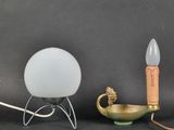 three different types of lamps on a black surface with a gray background