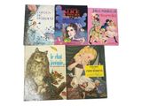 several children ' s books are lined up on a white surface