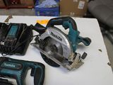two electric tools sitting on a table next to each other