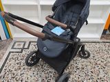 an image of a stroller sitting on a tiled floor in a room