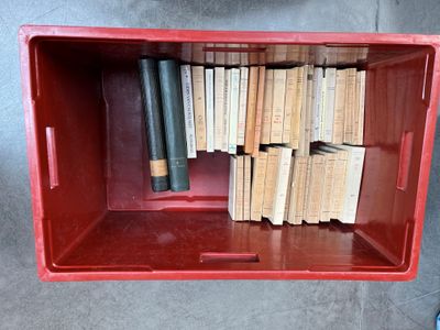 a red box with a bunch of books inside of it