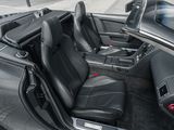 the interior of a sports car with its doors open