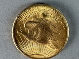 a close up of a gold coin on a white surface