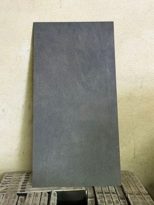a piece of metal sitting on top of a wooden table
