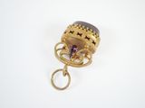 an image of a gold ring with a purple stone in it
