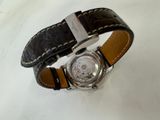 a watch that is sitting on a white surface