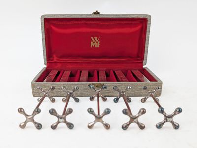 a wooden box with a bunch of metal objects inside of it
