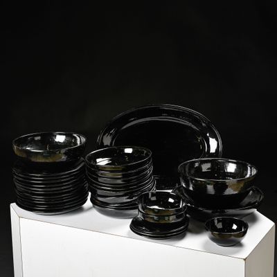 a white box with black plates and bowls on it