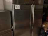 a refrigerator and freezer in a kitchen with a lot of boxes