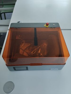 an orange plastic box with screws in it on a white table
