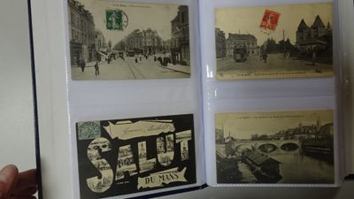 a person holding a book with pictures of a city