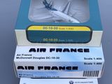 three boxes with a model of an airplane on top of them