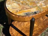 an image of a table with a marble top sitting in the grass