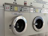 a row of washing machines lined up in a public washroom
