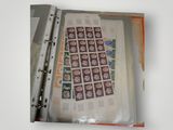 a binder with stamps on it and a sheet of paper