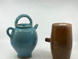 two vases that are next to each other on a table