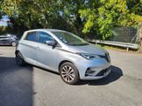 a silver car is parked on the side of the road