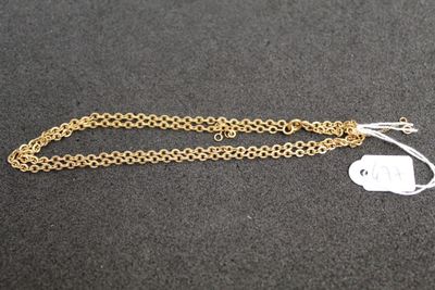 a close up of a gold chain with a tag attached to it