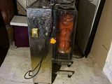 two machines that have carrots in them in a room