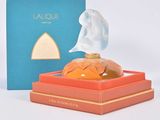an image of a perfume bottle sitting on top of a box