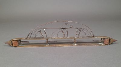 a metal sculpture of a boat on display on a table