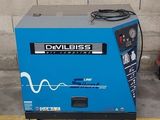 a blue machine that is sitting on the side of the road