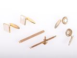 several different types of gold and silver jewelry on a white surface