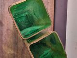 a small green box sitting on top of a wooden table