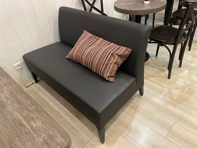 a couch with a pillow on it in a small room