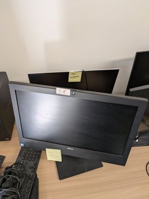 two monitors and a keyboard sitting on a desk
