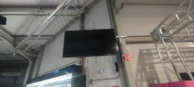 a television that is hanging from the ceiling in the room