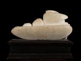 marble sculpture of a boat on a stand against a black background