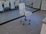 a white office chair sitting in front of a large mirror