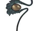 statue of a bird with a golden egg on a black base