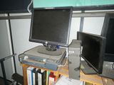 a desk with two monitors and a laptop on top of it
