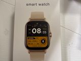 a box with a smart watch on it sitting on a table