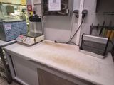 a kitchen with a counter, oven, and refrigerator
