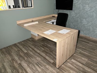 a wooden desk with a black chair in front of it