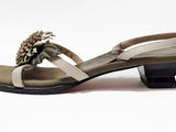 the woman is wearing a pair of sandals with a flower on the heel