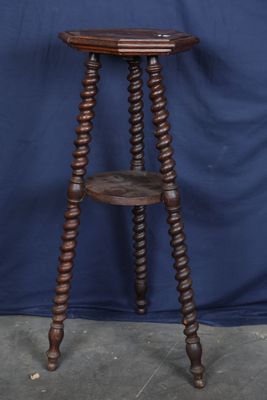 an old wooden table with a shelf on top of it