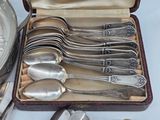 many spoons and forks in a case on a table