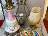a table with a lamp, a plate, and a plate on it