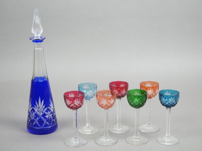 sept verres à vin et une carafe sur la table