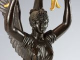 an image of a statue of a woman holding a basket with a bird on it
