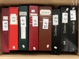 a lot of books in a box with labels on them