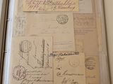 a binder with a lot of old letters and stamps on it