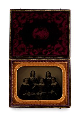 an old photo of a group of women sitting in a box
